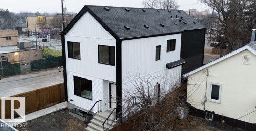 View of side of home featuring roof with shingles and a central air condition unit - 11738 91 Street Nw, Edmonton, AB - Outdoor With Exterior