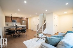 Living area with recessed lighting and light wood-style floors - 