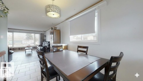Dining area with light tile patterned flooring - 4706 53 St, Leduc, AB - Indoor Photo Showing Dining Room