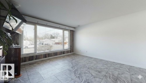 Empty room with baseboards and a textured ceiling - 4706 53 St, Leduc, AB - Indoor Photo Showing Other Room