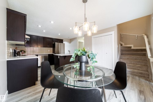 Dining area with light wood-style floors and hanging lights - 2919 15 Street, Edmonton, AB - Indoor Photo Showing Dining Room