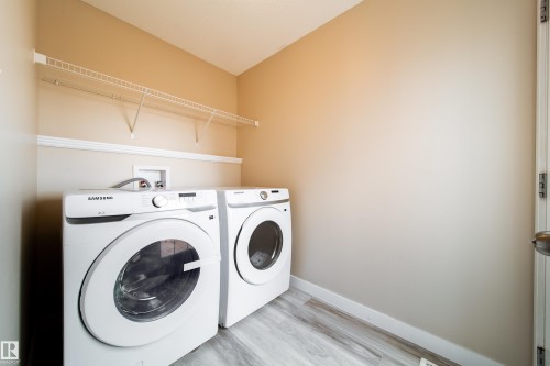 Laundry room with washing machine and dryer and wood finished floors - 2919 15 Street, Edmonton, AB - Indoor Photo Showing Laundry Room