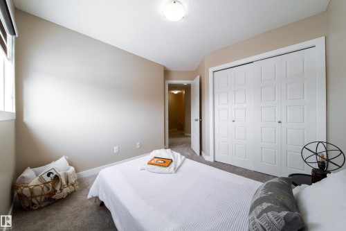 Carpeted bedroom featuring baseboards and a closet - 2919 15 Street, Edmonton, AB - Indoor Photo Showing Bedroom