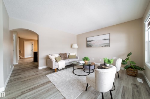Living area with arched walkways and light wood-style floors - 2919 15 Street, Edmonton, AB - Indoor Photo Showing Living Room