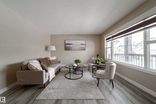 Living area featuring light wood-style flooring and a textured ceiling - 2919 15 Street, Edmonton, AB - Indoor Photo Showing Living Room