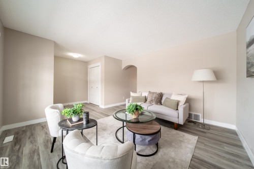 Living area featuring arched walkways and light wood-style flooring - 2919 15 Street, Edmonton, AB - Indoor Photo Showing Living Room