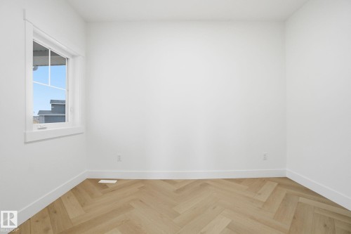 Spare room with parquet flooring and baseboards - 3294 Chernowski Way, Edmonton, AB - Indoor Photo Showing Other Room