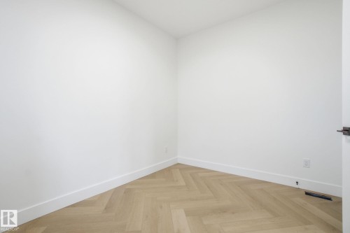 Spare room with parquet flooring and baseboards - 3294 Chernowski Way, Edmonton, AB - Indoor Photo Showing Other Room