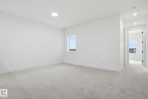 Empty room featuring light colored carpet and recessed lighting - 3294 Chernowski Way, Edmonton, AB - Indoor Photo Showing Other Room