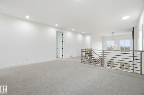 Empty room with light colored carpet and recessed lighting - 3294 Chernowski Way, Edmonton, AB - Indoor Photo Showing Other Room