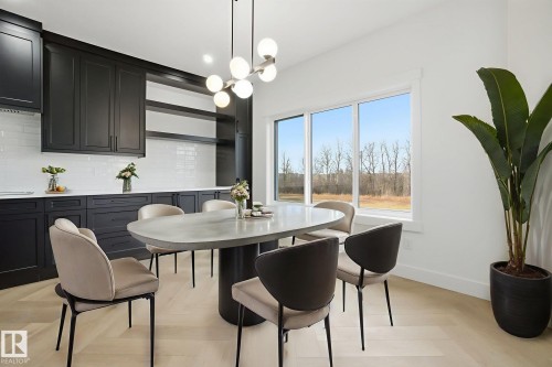 Dining room with a chandelier and parquet floors - 3294 Chernowski Way, Edmonton, AB - Indoor Photo Showing Dining Room