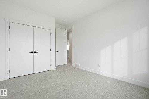 Unfurnished bedroom featuring light colored carpet and a closet - 3294 Chernowski Way, Edmonton, AB - Indoor Photo Showing Other Room