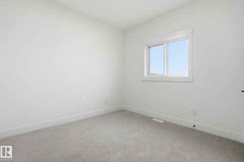 Empty room featuring light carpet and baseboards - 3294 Chernowski Way, Edmonton, AB - Indoor Photo Showing Other Room