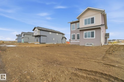 Back of house featuring board and batten siding - 3294 Chernowski Way, Edmonton, AB - Outdoor