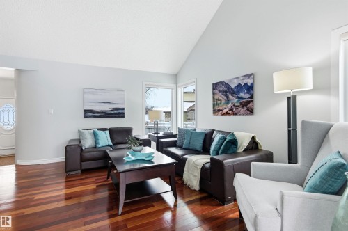 Living area featuring vaulted ceiling and hardwood / wood-style floors - 326 O'Connor Close, Edmonton, AB - Indoor Photo Showing Living Room