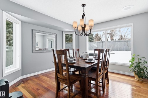 Dining space with wood-type flooring and suspended lighting - 326 O'Connor Close, Edmonton, AB - Indoor Photo Showing Dining Room