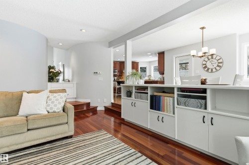 Living area featuring dark wood-type flooring and a chandelier - 326 O'Connor Close, Edmonton, AB - Indoor