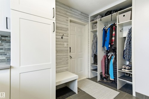 Mudroom with a textured ceiling and dark tile patterned flooring - 326 O'Connor Close, Edmonton, AB - Indoor With Storage