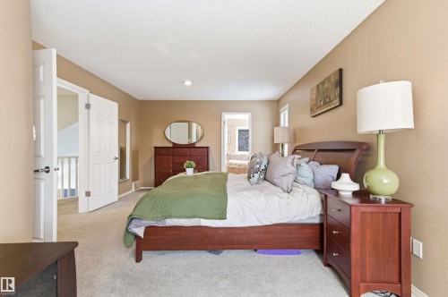 Bedroom with ensuite bathroom and light colored carpet - 326 O'Connor Close, Edmonton, AB - Indoor Photo Showing Bedroom