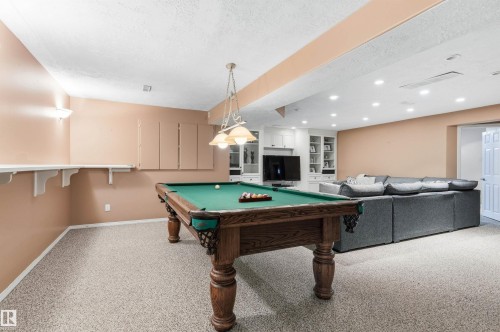 Playroom featuring billiards, a textured ceiling, light colored carpet, and recessed lighting - 326 O'Connor Close, Edmonton, AB - Indoor Photo Showing Other Room