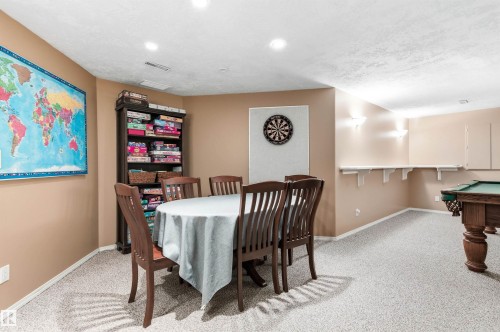 Dining area with pool table, light carpet, and a textured ceiling - 326 O'Connor Close, Edmonton, AB - Indoor