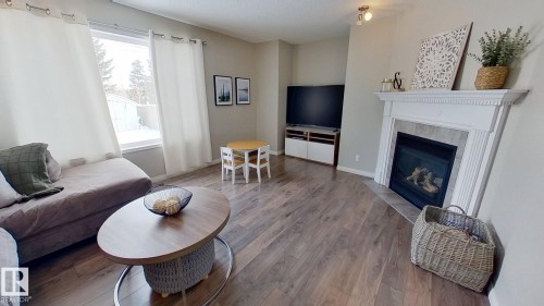 24 Pipestone Drive, Devon, AB - Indoor Photo Showing Living Room With Fireplace