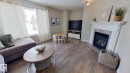 24 Pipestone Drive, Devon, AB  - Indoor Photo Showing Living Room With Fireplace 