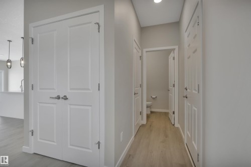 Hallway featuring light wood-style flooring - 5657 Hawthorn Way, Edmonton, AB - Indoor Photo Showing Other Room