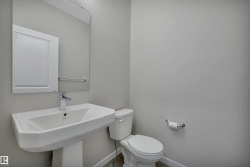 Bathroom with toilet and baseboards - 5657 Hawthorn Way, Edmonton, AB - Indoor Photo Showing Bathroom