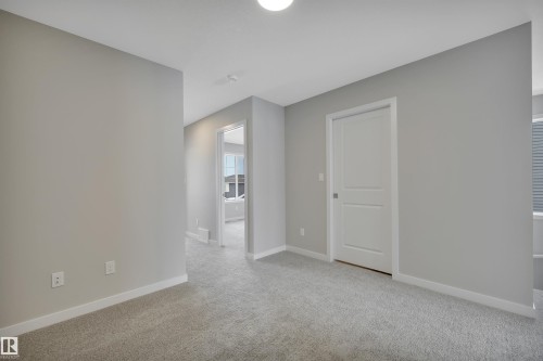 Empty room with baseboards and light colored carpet - 5657 Hawthorn Way, Edmonton, AB - Indoor Photo Showing Other Room