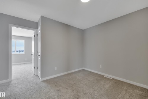 Unfurnished room with light colored carpet and baseboards - 5657 Hawthorn Way, Edmonton, AB - Indoor Photo Showing Other Room