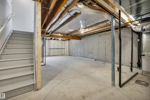 Unfinished basement with stairway and heating unit - 5657 Hawthorn Way, Edmonton, AB - Indoor Photo Showing Basement