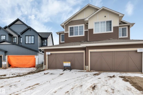 View of front of property with an attached garage and a shingled roof - 5657 Hawthorn Way, Edmonton, AB - Outdoor