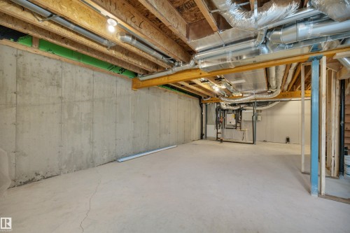 Unfinished below grade area featuring heating unit - 5657 Hawthorn Way, Edmonton, AB - Indoor Photo Showing Basement