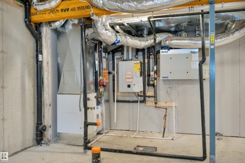 Utility room with water heater and heating unit - 5657 Hawthorn Way, Edmonton, AB - Indoor Photo Showing Basement