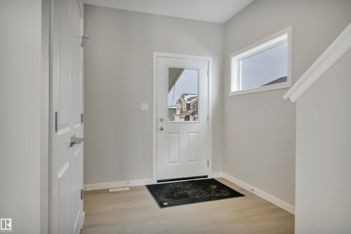 Doorway with baseboards and wood finished floors - 5657 Hawthorn Way, Edmonton, AB - Indoor Photo Showing Other Room