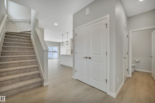 Stairs featuring wood finished floors and recessed lighting - 5657 Hawthorn Way, Edmonton, AB - Indoor Photo Showing Other Room