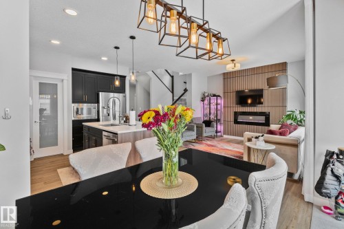Dining room featuring a fireplace, light wood-style floors, and recessed lighting - 324 41 Street, Edmonton, AB - Indoor Photo Showing Other Room