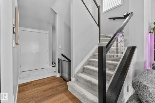Staircase with wood finished floors and baseboards - 324 41 Street, Edmonton, AB - Indoor Photo Showing Other Room