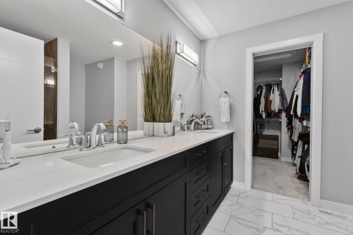 Bathroom featuring double vanity, a walk in closet, and light marble finish flooring - 324 41 Street, Edmonton, AB - Indoor Photo Showing Bathroom