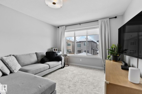 Bonus area featuring light carpet and baseboards - 324 41 Street, Edmonton, AB - Indoor Photo Showing Living Room