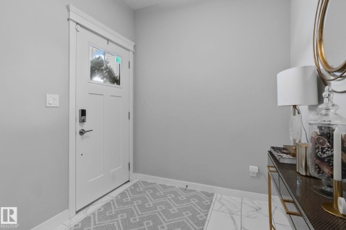 Foyer featuring baseboards and light marble finish flooring - 324 41 Street, Edmonton, AB - Indoor