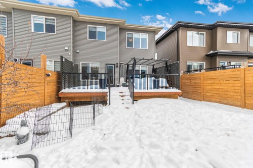 Snow covered rear of property featuring a fenced backyard and a wooden deck - 324 41 Street, Edmonton, AB - Outdoor With Deck Patio Veranda With Exterior