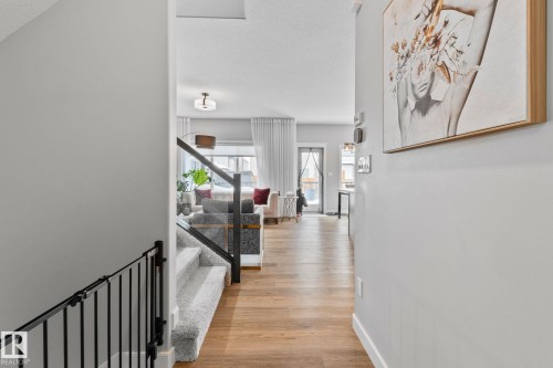 Hall featuring light wood-style floors and a textured ceiling - 324 41 Street, Edmonton, AB - Indoor Photo Showing Other Room