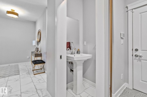 Half bathroom featuring light marble finish floors - 324 41 Street, Edmonton, AB - Indoor Photo Showing Bathroom