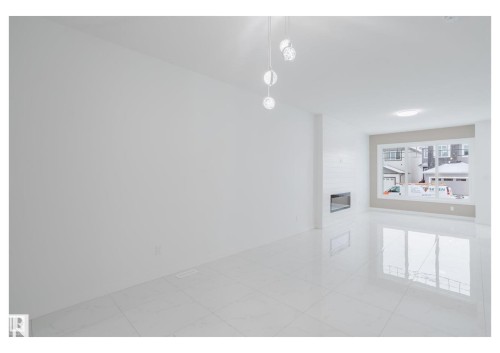 Empty room with a fireplace - 231 25 Street Sw, Edmonton, AB - Indoor Photo Showing Other Room