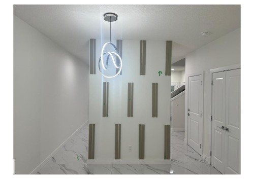Hallway featuring light marble finish floors and a textured ceiling - 231 25 Street Sw, Edmonton, AB - Indoor Photo Showing Other Room