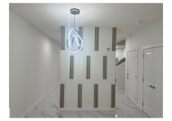 Hallway featuring light marble finish floors and a textured ceiling - 