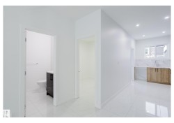 Hall featuring light marble finish floors and recessed lighting - 