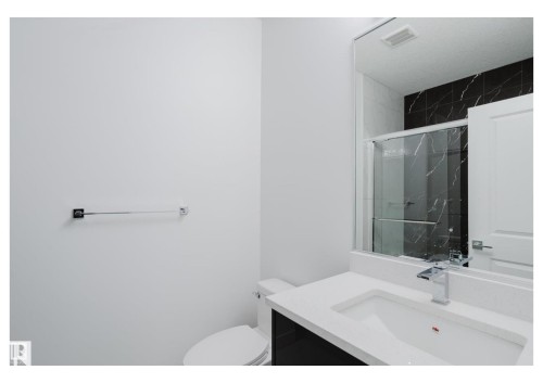 Bathroom featuring vanity and a marble finish shower - 231 25 Street Sw, Edmonton, AB - Indoor Photo Showing Bathroom